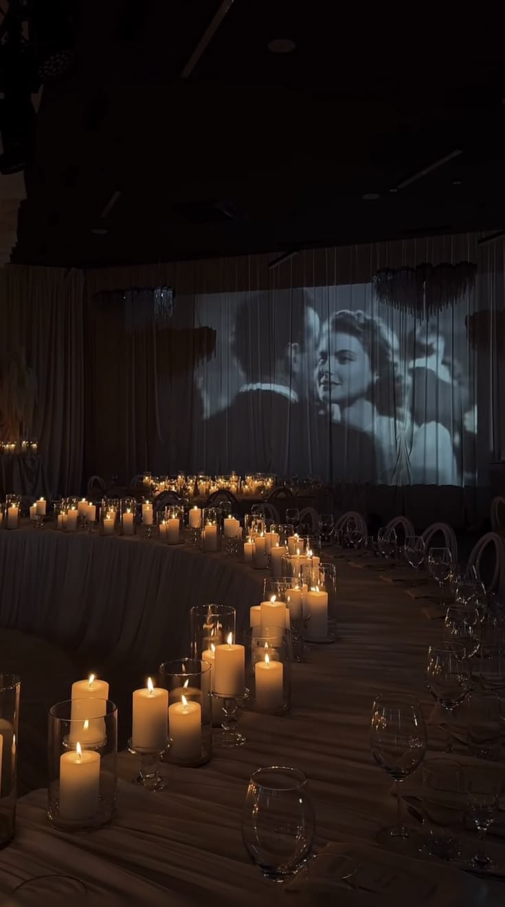 Black-and-white film projected during a candlelit wedding dinner