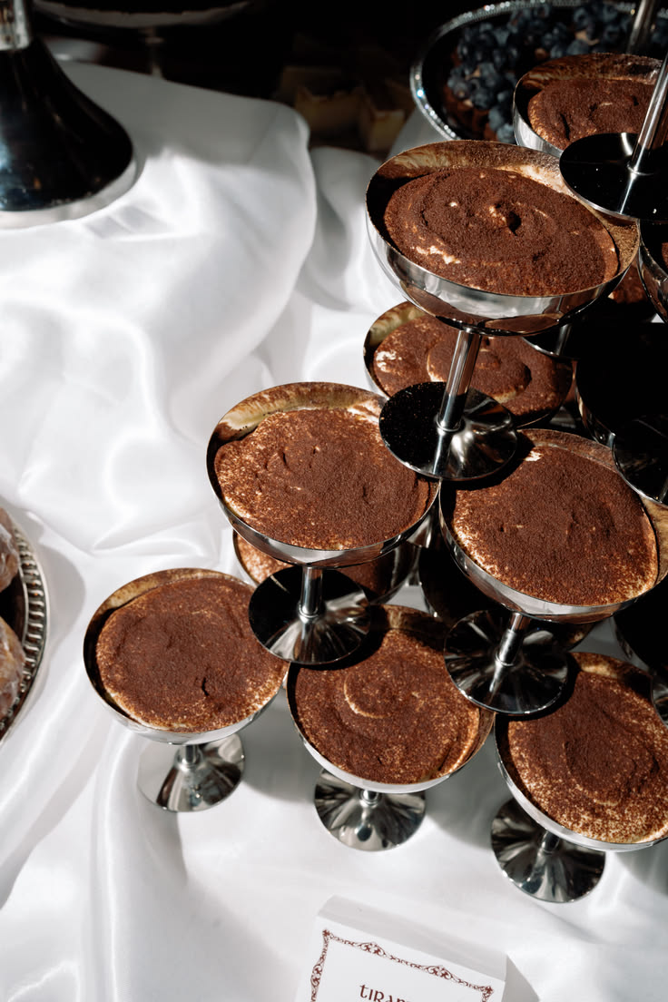 Individual tiramisus served in stainless steel coupes, an alternative to the tiered cake